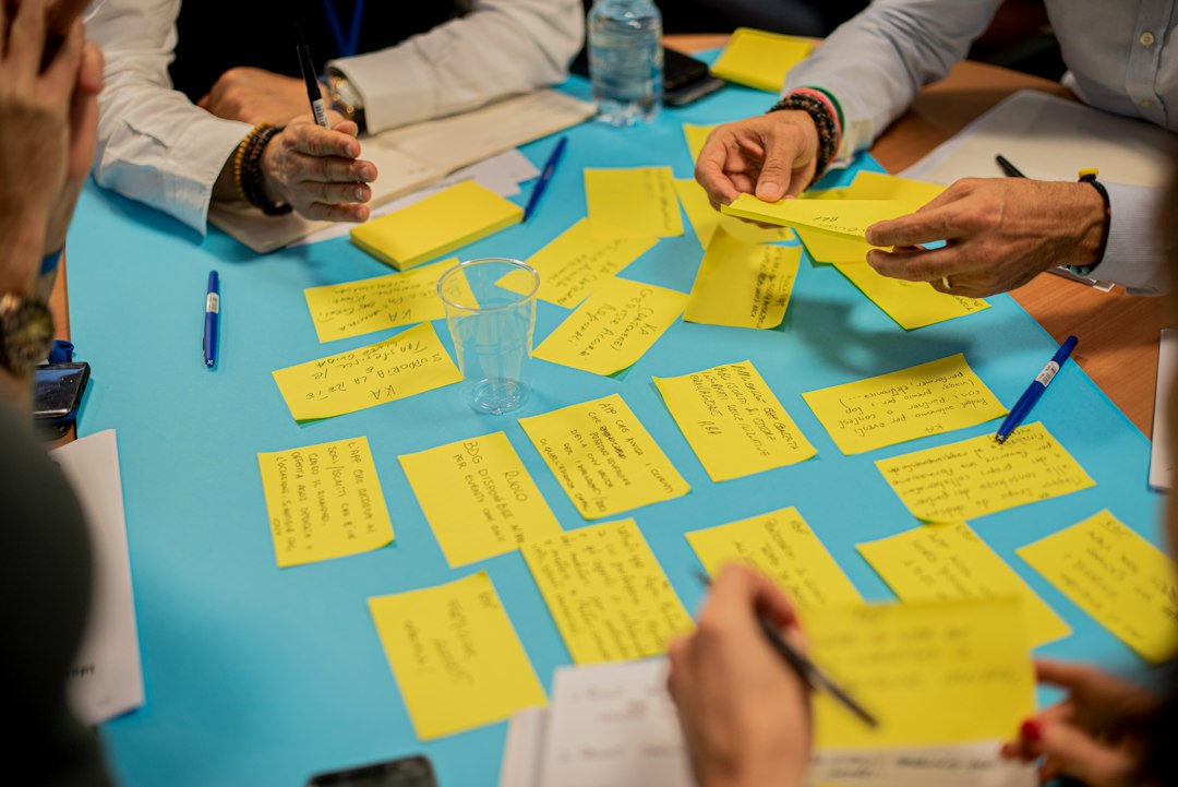 Participants sharing ideas with sticky notes during a workshop
